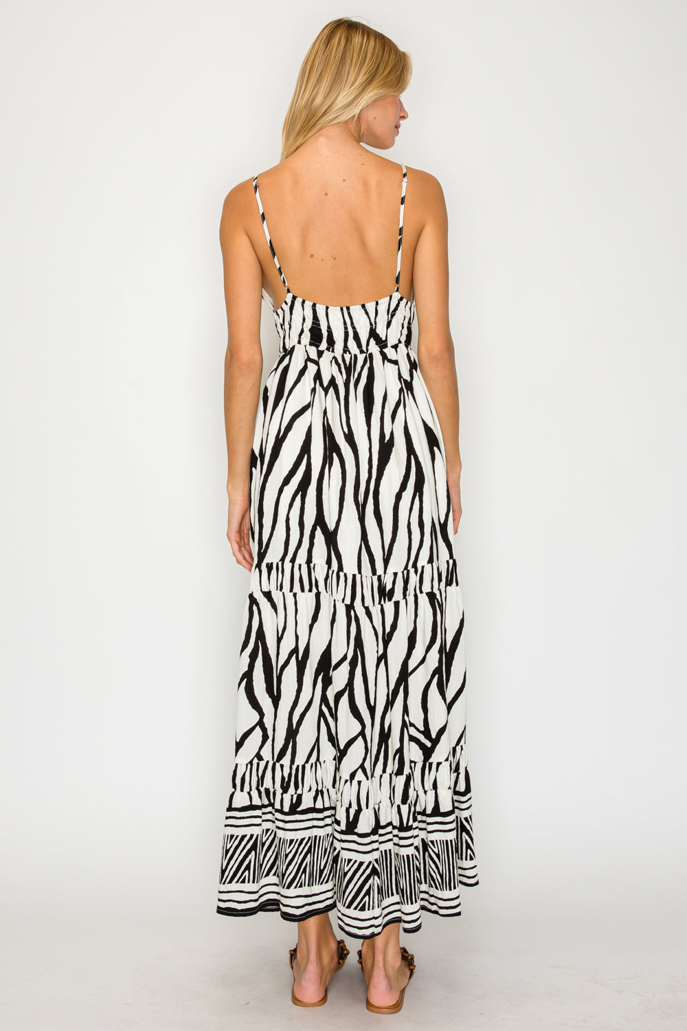 Woman wearing a zebra print dress on a white background