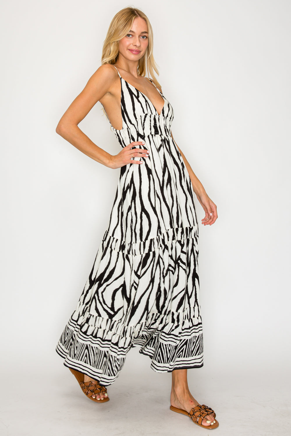 Woman wearing a zebra print dress on a white background