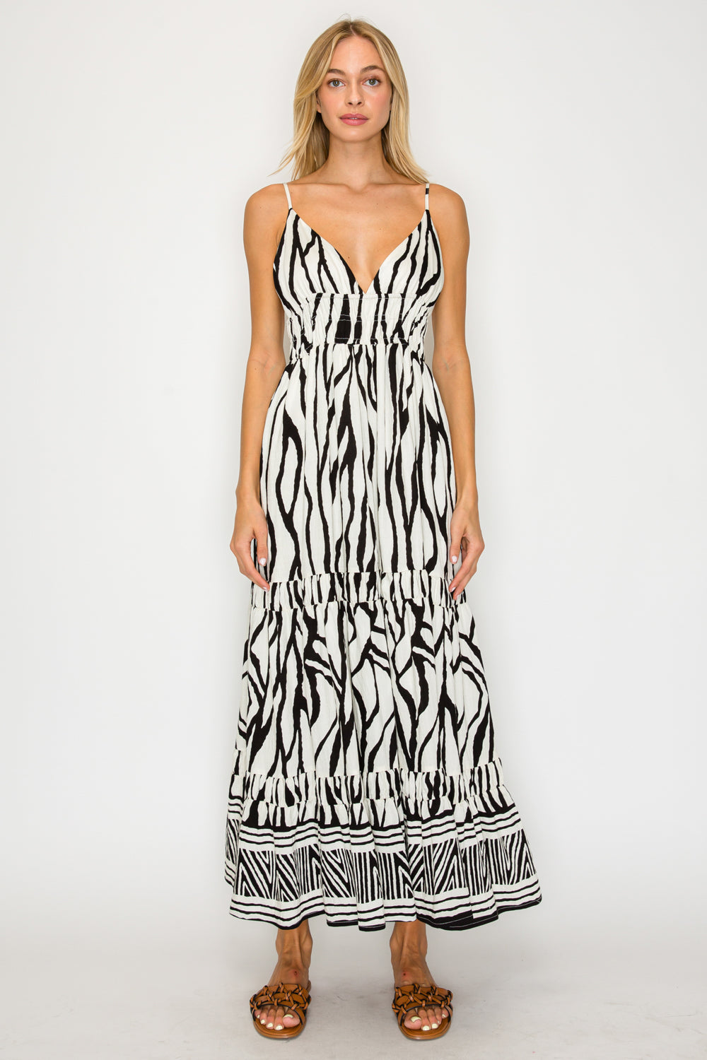 Woman wearing a black and white patterned dress on a white background