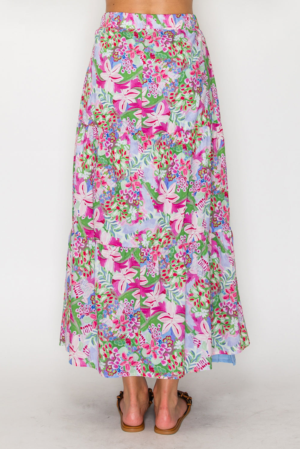 Floral patterned skirt worn by a person on a white background