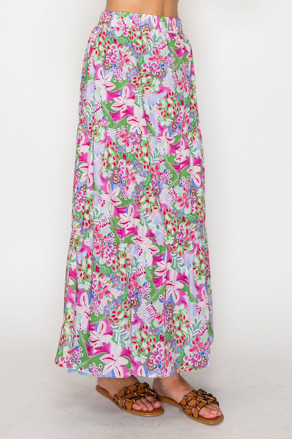 Floral patterned skirt worn by a person on a white background